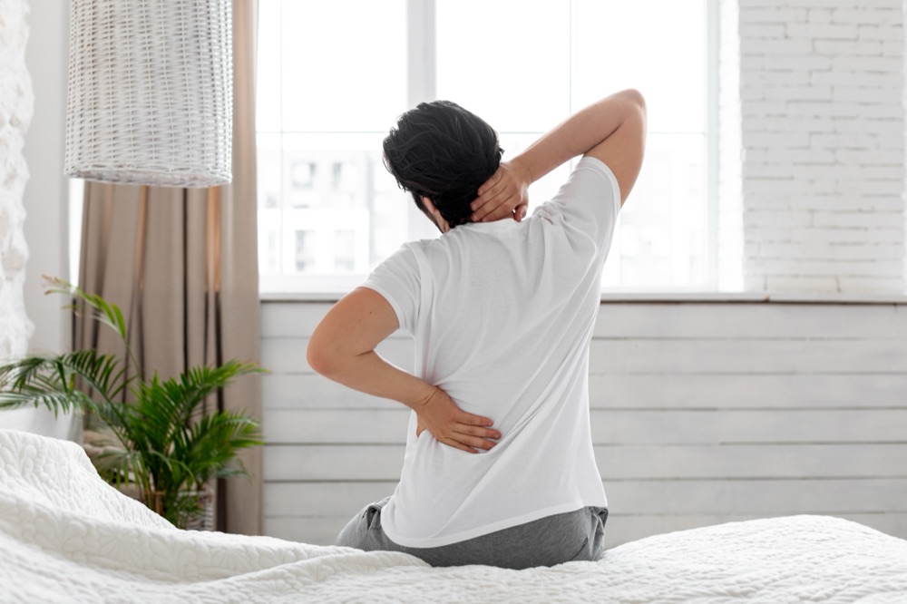 Person in bed with morning back pain